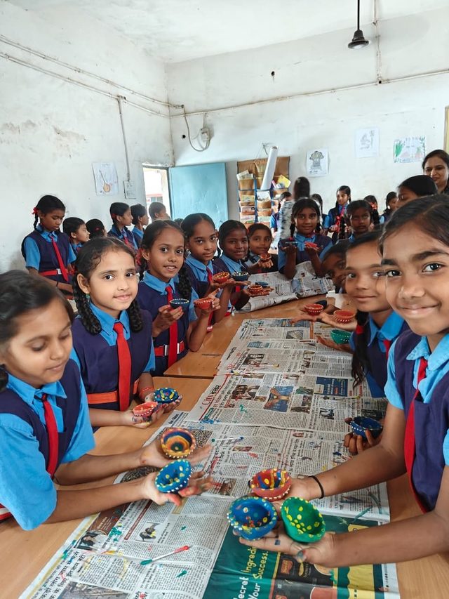 A child at a diya making workshop